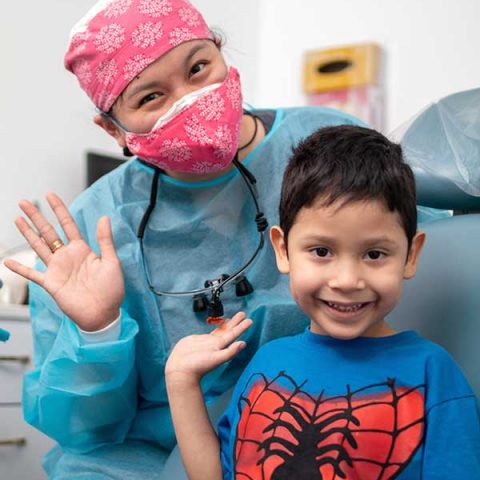 Happy kid with dentist after a successful visit to Dental Park in McAllen, TX